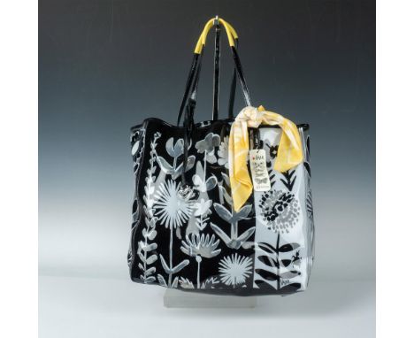 Clear vinyl bag decorated with black and white floral and insect design. Black patent leather trim and handles are accented b