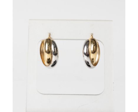 White and yellow gold twisted hoop earrings stamped 14k on the post. Dimensions: 0.75" dia. Condition: Age related wear. 