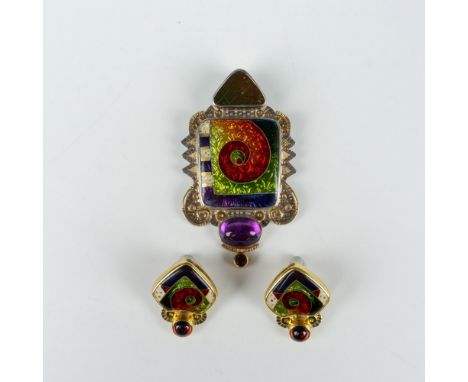 This stunning pendant has both a bail and pin so it can be worn on a necklace or as a brooch. It displays brightly colored en