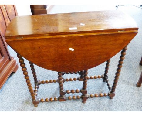 An 18th century style oak bobbin turned oval gate-leg tea table, 70cm wide