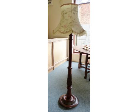A turned wood standard lamp with shade 