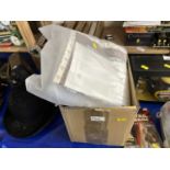 A box of various assorted singles and a quilting cushion