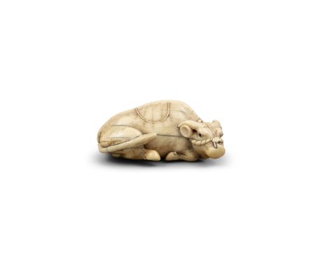 λ A CARVED IVORY NETSUKE OF A RECUMBENT OX.Japan, Meiji period (1868-1912)Modelled with head turned to the right, tethered wi