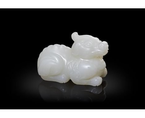 A WHITE JADE CARVING OF A QILIN清代 白玉麒麟The mythical beast is intricately carved and with the head facing forwards and the legs