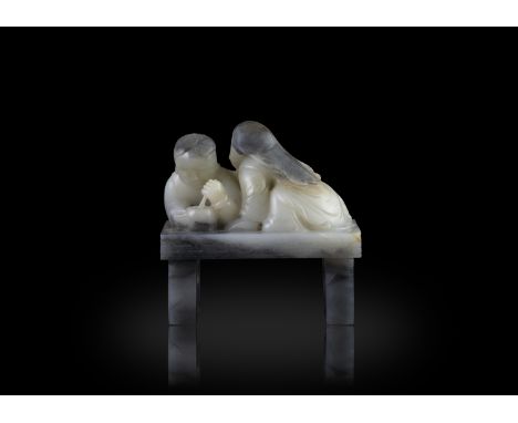 A BLACK AND WHITE JADE GROUP清代 黑白玉巧雕嬰戲擺件China, late Qing dynastyCarved, depicting two children playing on a bench. One is lyi