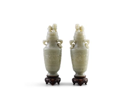 A PAIR OF JADE VASESwith two wooden stands and two capsH: 21cm (excluding wooden base)Condition Report:- One ring is missing