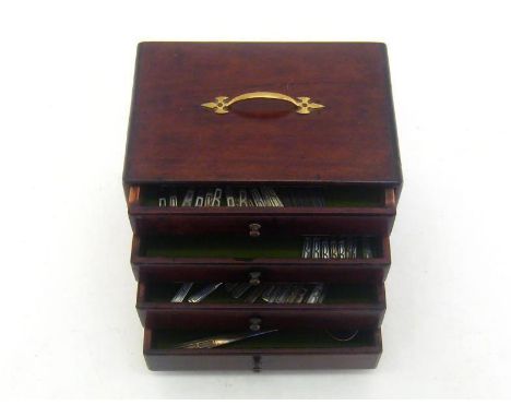 A brass-handled mahogany four-drawer canteen containing a silver-plated Art Deco part canteen initialled "B", by Walker & Hal