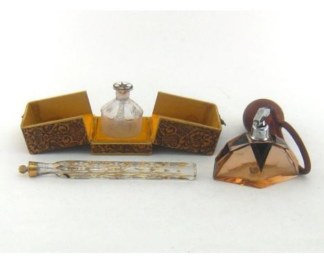 An Art Deco perfume atomiser with chromium mounts, circa 1930, the faceted sunrise shaped peach glass bottle with black trian