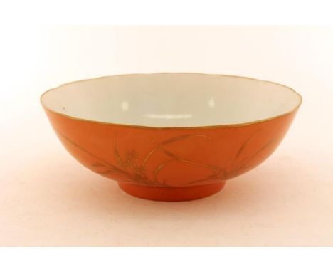 A Chinese coral red ground gilt orchid bowl, with finely rounded deep body and gilt floral rim, the exterior covered in an el