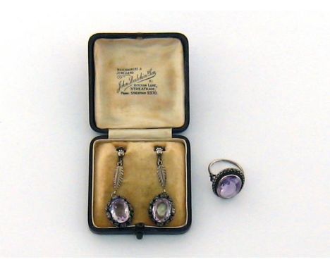 A pair of early 20th century white metal and amethyst pendant earrings, possibly German, each drop set with an oval mixed cut