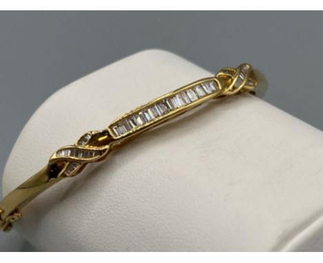 18ct gold 1.7ct diamond set bangle. Comprising of 42 baguette cut diamonds complete with figure 8 safety catch. 18.3G and cts