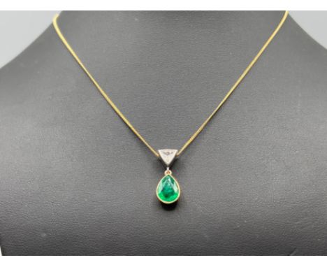 18ct gold Emerald and Diamond drop pendant and 18ct gold chain. Set with trapeze cut diamond and pear shaped emerald. 5.6g