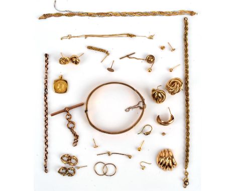 A collection of jewellery items including a broken bangle, a T-Bar pendant, single earrings, broken chains and other items, a