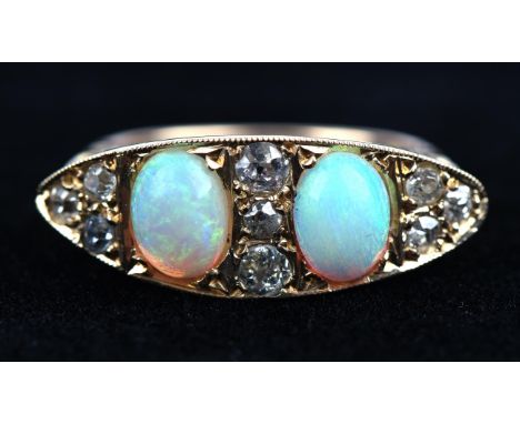 An antique opal and diamond carved half hoop ring, set with two oval cabochon cut opals weighing an average 0.55ct each, with