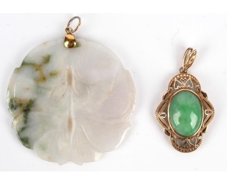 Two jade pendants, including a jade pendant with an openwork gold surround, tested as 14 ct, and a carved disc pendant depict