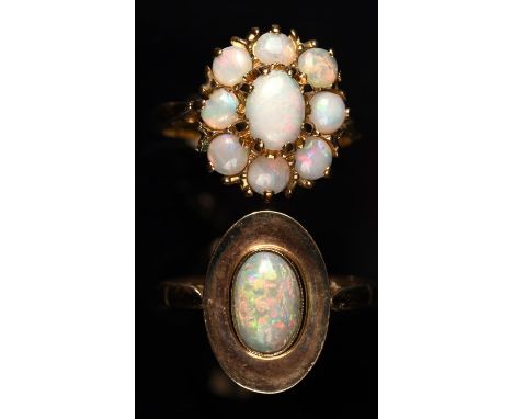 Two opal rings, one contemporary single stone opal ring, set with a oval cabochon opal, mount  stamped 9 ct, ring size N, wit