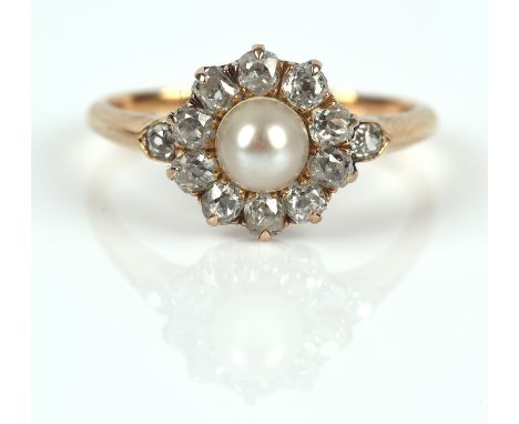 Antique pearl and diamond ring, with central pearl measuring 5mm, surrounded by old cut diamonds, with diamond set shoulders,
