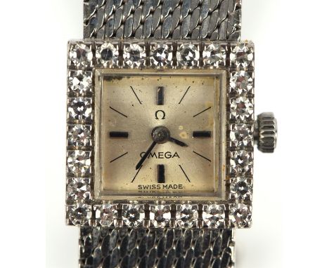 Omega,  A Ladies Gold wristwatch, the diamond set bezel surmounting a silvered signed dial with baton hour markers, fitted wi
