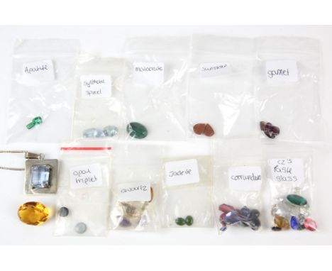 Loose gemstones including amethysts, citrines, synthetic spinel, synthetic corundum, opal doublets, and more together with a 