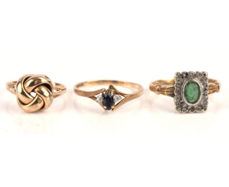 Three rings, an emerald and diamond dress ring, size L, a sapphire and diamond ring, size M and a knot ring, size F, all in 9