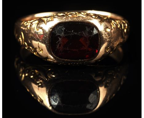 Garnet dress ring, bezel set with a cushion cut garnet, estimated weight 2.10 carats, with scroll engravings to the sides, mo