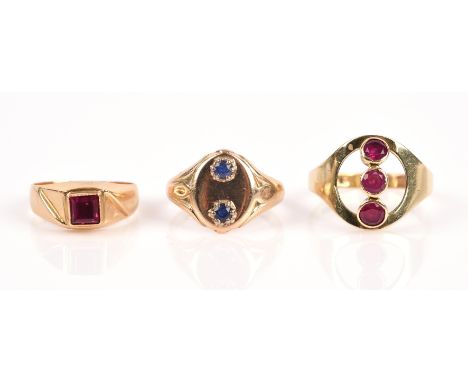 Three gem set rings, one a three stone openwork ruby ring, in 14 ct, size K, one a two stone sapphire signet style ring in 9 