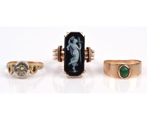 Three rings including a cameo ring with multi band shank, in tested 9 ct, size I, a green hardstone ring in 18 ct, size G, an