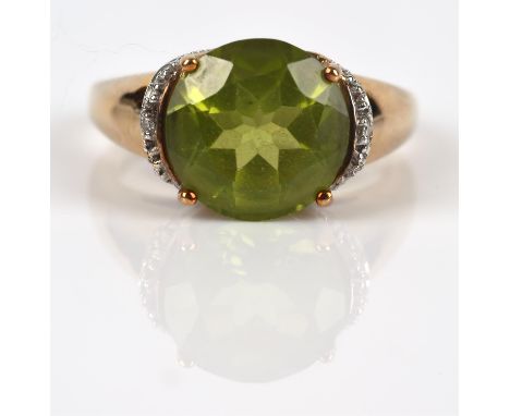 Peridot and diamond ring, central round cut peridot weighing a stated 4.26 carats, claw set, with round brilliant diamond acc