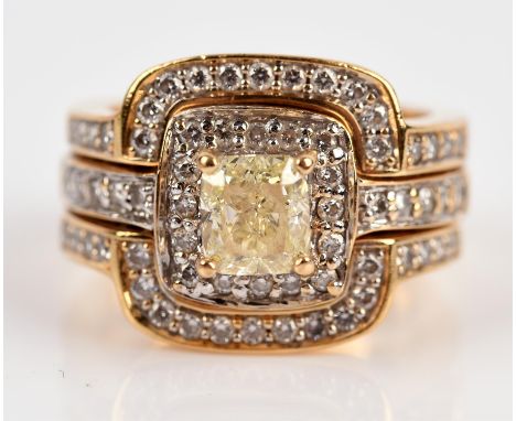 Modern diamond cluster ring, central light yellow diamond weighing a stated 1.00 carat, claw set, with a surround of round br