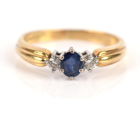 Sapphire and diamond three stone ring, with central oval sapphire flanked either side by a round brilliant cut diamond, claw 