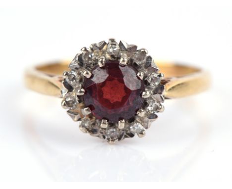 Vintage garnet and diamond cluster ring, with central round cut garnet and a surround of single cut diamonds, mounted in 18 c