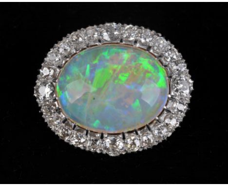 Opal and diamond brooch, with central oval cabochon opal weighing an estimated 11.14 carats, with a surround of 24 old cut di