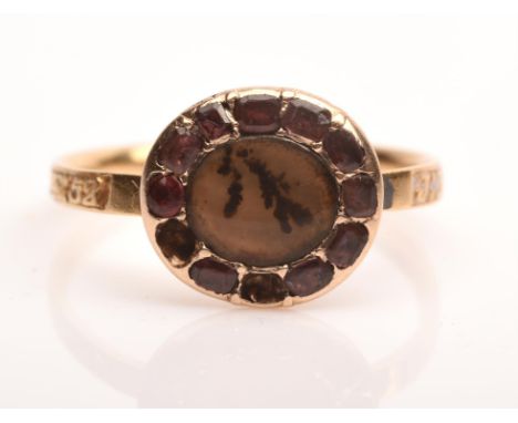 Georgian moss agate and garnet cluster ring, with central oval moss agate with a surround of garnets, with an engraved shank 