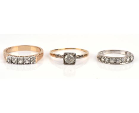 Three paste rings, including a single stone paste ring in 18 ct size R, a six stone paste ring in 18 ct, size K, and a gold p