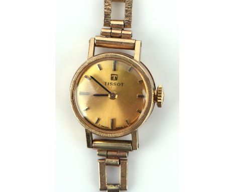 Tissot  A Ladies Gold wrist watch, the signed brushed gold dial with baton hour markers,fitted with a signed 17 jewel manual 