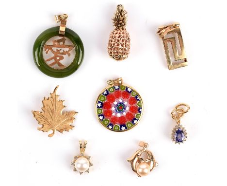 A selection of pendants including a jade pendant with symbol to the centre, a pineapple, a pearl pendant set to the centre of