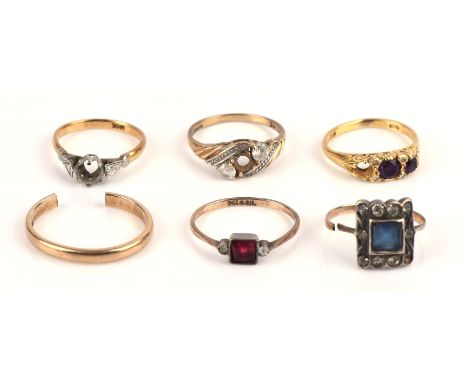 A collection of rings including a cut wedding band in 9 ct, a carved three stone amethyst ring missing a stone in 9 ct, size 