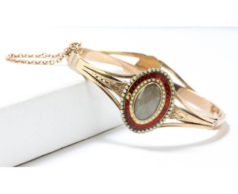 Gold oval bangle, comprised of two re-worked Georgian rings, one with central hair compartment, red enamel and seed pearl bor