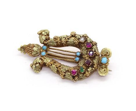 A Georgian regard lyre brooch, the arms of the lyre are finely engraved with bunches of grapes and leaves, the bridge is set 