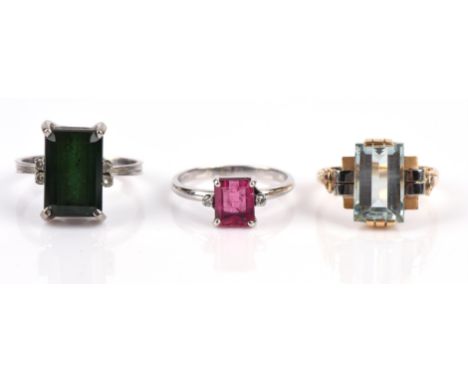 Three gem set rings including an emerald-cut green tourmaline ring with single cut diamonds each side, size N, and an emerald