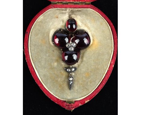 Late Victorian foil backed cabochon cut garnet pendant, set with rose cut diamonds in central clover lead design and articula
