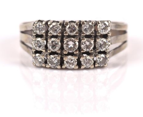 Diamond three row ring, with round brilliant diamonds claw set, estimated total diamond weight 0.60 carats, mount testing as 