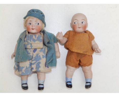 A small pair of bisque head girl &amp; boy dolls with painted googly eyes, 5". (2)