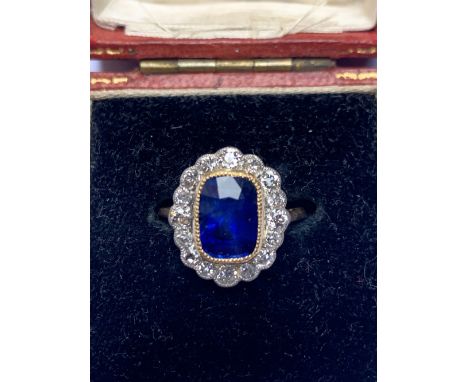 A  certified natural 3.03 carat Sri-Lankan sapphire &amp; diamond oval cluster ring in 18ct yellow gold, accompanied by a Gem