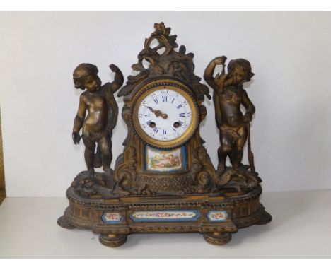 A 19thC French ormolu mantel clock by Deprez, Paris, the convex enamel dial flanked by a pair of putti, the case set with sma
