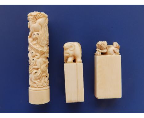 Two late 19th/early 20thC  Chinese ivory desk seals, one with an elephant, the other with a shishis, on plain rectangular bas