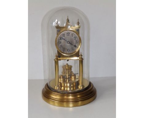 A domed brass anniversary clock by Gustav Becker, with revolving platform, 11.5" overall height.