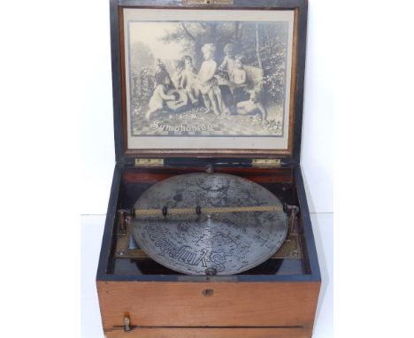 An early 20thC Symphonian disc playing musical box, in walnut case with 18  10" discs, the box 13" across.