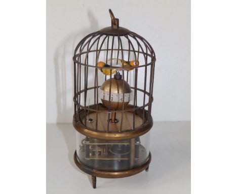 A small 20thC automaton bird cage clock, two birds above a spherical chapter ring, 7.5" high overall.