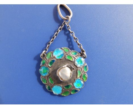 An enamelled 950 silver art nouveau pendant by Murrle Bennett &amp; Co, of circular flower garland design - attention needed 